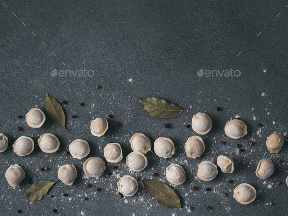 Beautiful scattered raw pelmeni on marble background - Stock Photo - Images