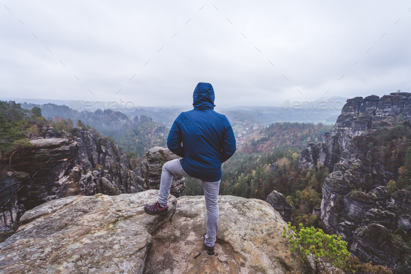 Hiker in outdoor adventure hike trail trip on the top of a mountain, enjoying view of ridge in the - Stock Photo - Images