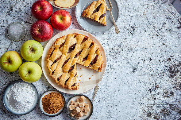 Delicious apple pie cake with a fresh fruits, brown and powder sugar - Stock Photo - Images