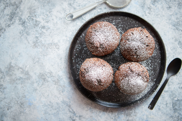 Fresh and tasty chocolate muffins served on plate - Stock Photo - Images