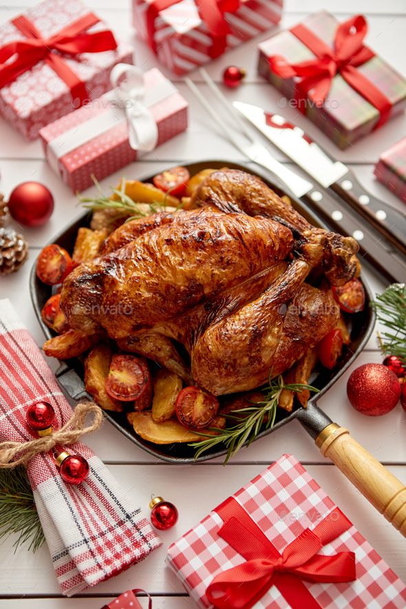 Roasted whole chicken or turkey served in iron pan with Christmas decoration - Stock Photo - Images