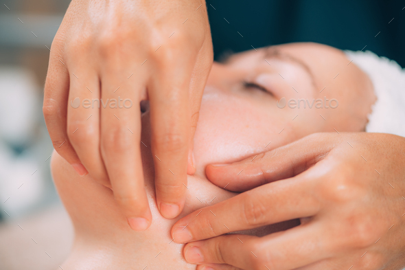 Woman Receiving Facial Fitness Lifting Massage