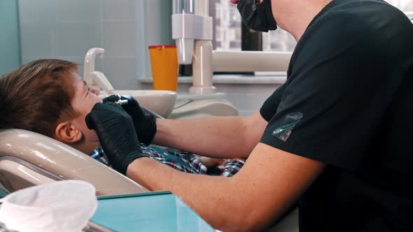 A Little Stressful Boy Getting His Primary Teeth Done in the Modern Dentistry alt