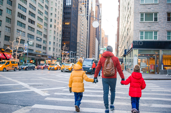 Family of father and little kids on Times Square during their vacation ...