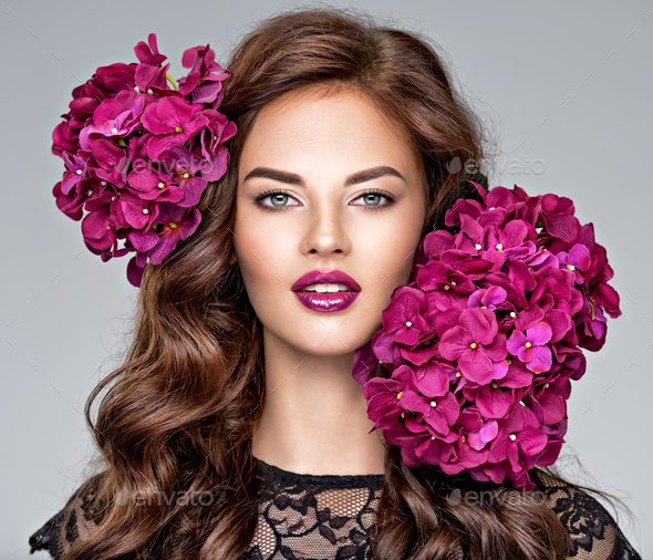 Beautiful woman with bright purple makeup. - Stock Photo - Images