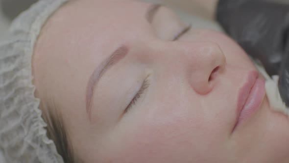 Closeup of Woman Face During Cosmetic Skin Cleansing at Cosmetologist
