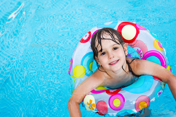 Little girl in swimming pool with float ring Stock Photo by nd3000