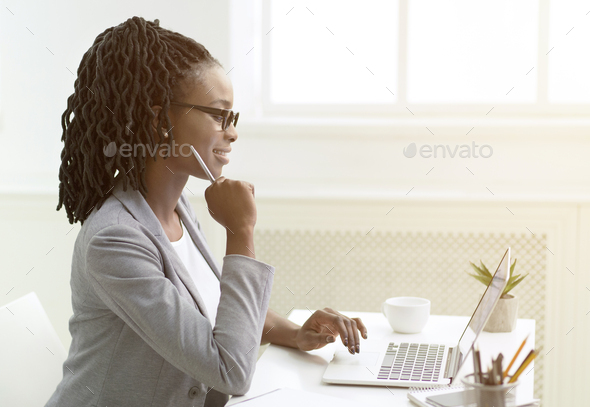Black Entrepreneur Lady Using Laptop Typing Sitting At Work Indoor