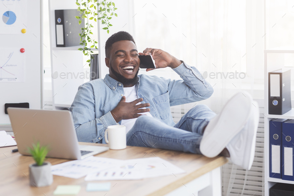 Laughing african american employee having break in work
