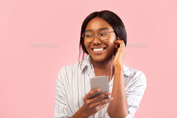 Cheerful Black Girl Standing Using Phone Listening Music, Studio Shot Stock  Photo by Prostock-studio