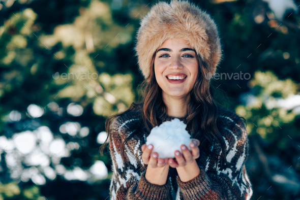 Young woman enjoying the snowy mountains in winter - Stock Photo - Images