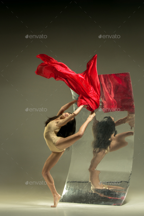 Young and stylish modern ballet dancer on brown background
