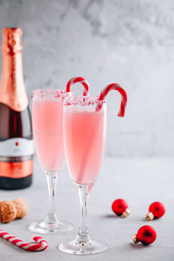 Festive Christmas drink Peppermint Bark Mimosa cocktail with champagne or prosecco and candy cane - Stock Photo - Images