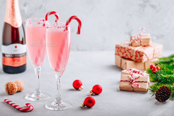 Festive Christmas drink Peppermint Bark Mimosa cocktail with champagne or prosecco and candy cane - Stock Photo - Images