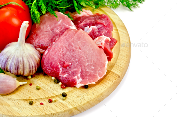 Meat slices on a round plate with vegetables - Stock Photo - Images