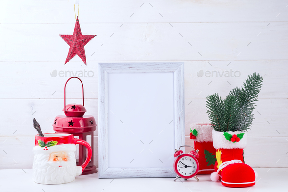 Photo mock up with white frame, Poinsettia in a flowerpot and red lantern on white wooden background - Stock Photo - Images