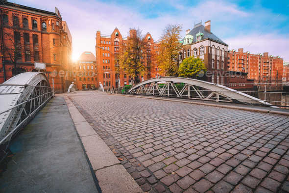 Arch bridge over canals with cobbled road in the Speicherstadt of Hamburg, Germany, Europe