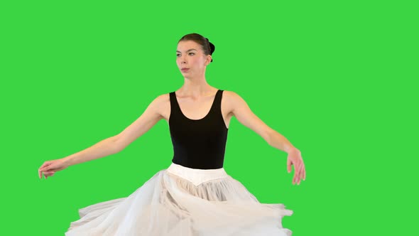 Ballerina in a Romantic Tutu and Pointe Ballet Shoes Training Fouette on a Green Screen Chroma Key alt