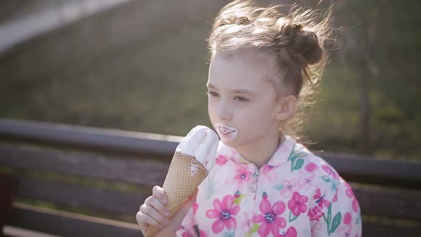 Little Girl Eating Ice Cream in the Park