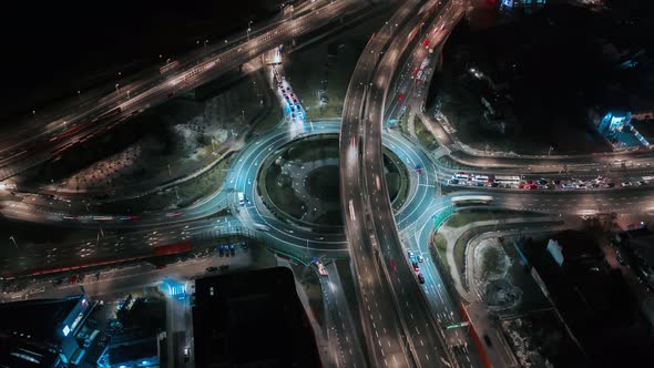 Aerial Drone Time Lapse Car Traffic Jam Roundabout Circle Interchange Road at Night Top View alt