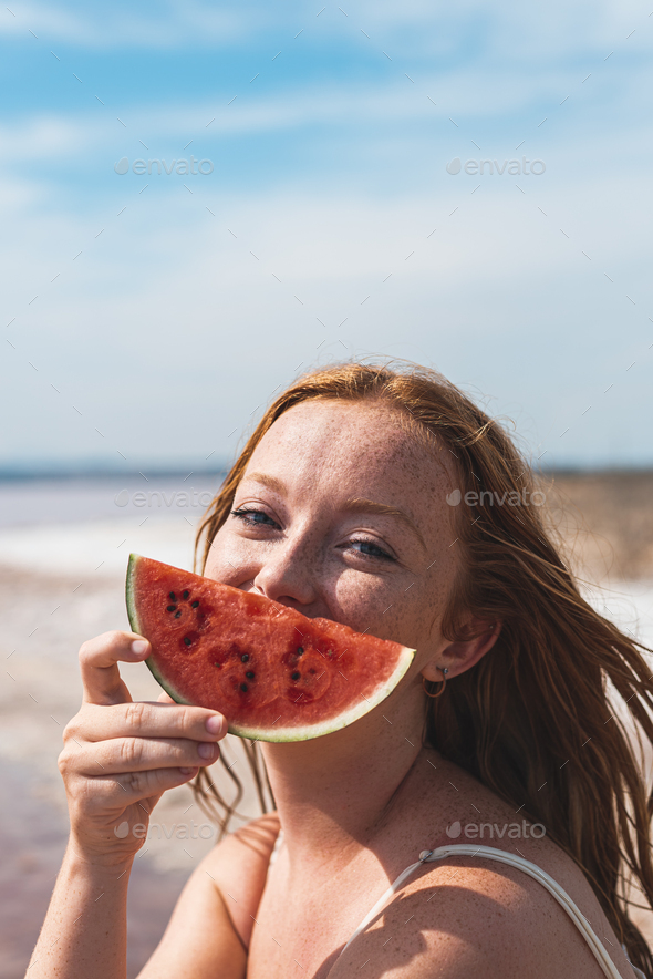 cute teenager woman covering face with watermelon smiling - Stock Photo - Images