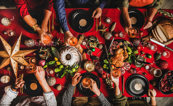 Christmas or New Year party. Flat-lay of people feasting at decorated table - Stock Photo - Images