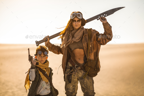 Post-apocalyptic Woman and Boy Outdoors in a Wasteland - Stock Photo - Images