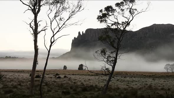 Timelapse of Mist Shot Early in the Morning Against a Mountain Backdrop alt