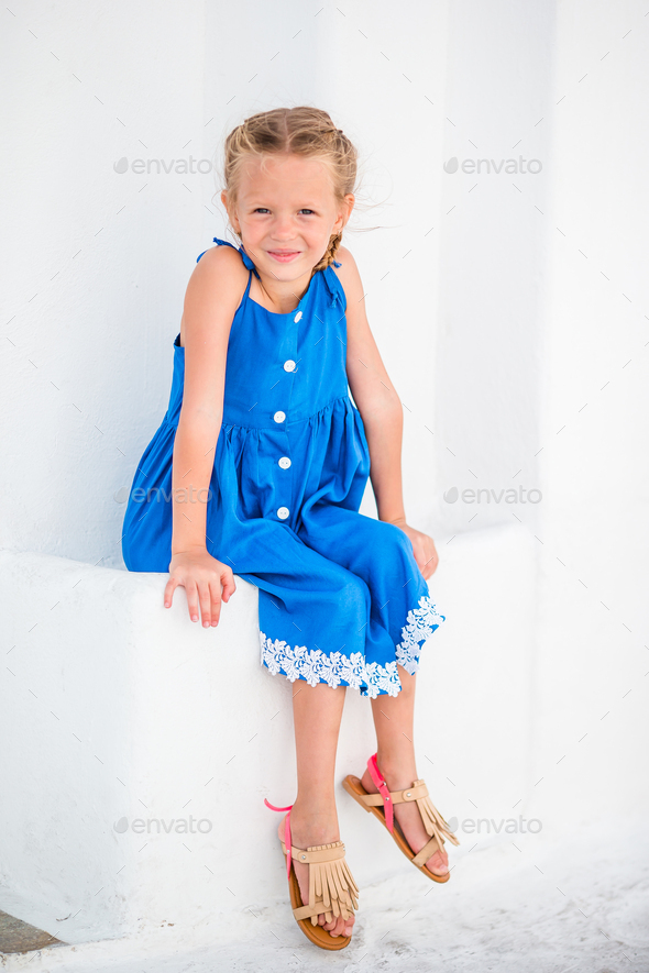 Girl in blue dresses having fun outdoors on Mykonos streets - Stock Photo - Images
