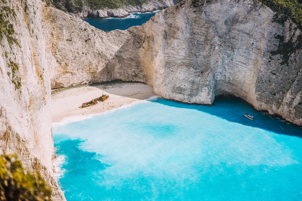 Navagio beach with turquoise blue sea water surrounded by huge white cliffs. Famous landmark - Stock Photo - Images