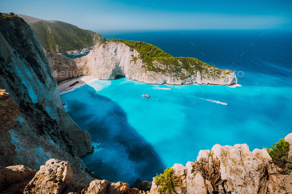 Navagio beach, Zakynthos island, Greece. Tourist boats visiting Shipwreck bay with azure water and - Stock Photo - Images