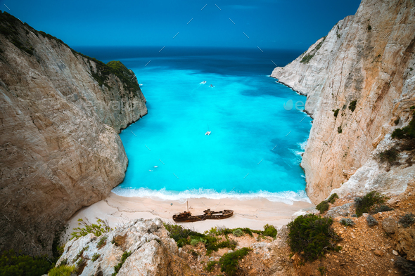 Shipwreck in Navagio beach. Azure turquoise sea water and paradise sandy beach. Famous tourist - Stock Photo - Images