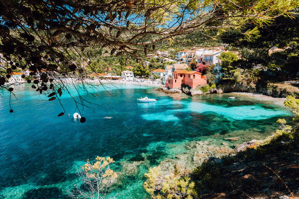 Lovely bay of assos village, Kefalonia, Greece. View on tourquise transparent water framed between - Stock Photo - Images