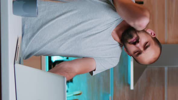 Vertical Video Tired Man Working From Home Streatching alt