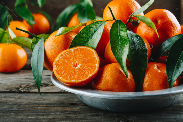 Fresh Clementine Mandarin Oranges fruits or Tangerines with leaves on  wooden background Stock Photo by nblxer