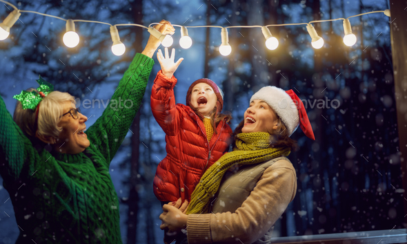 family with garlands outside - Stock Photo - Images