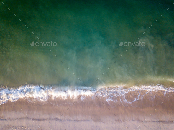 Drone picture of waves hitting the beach. - Stock Photo - Images