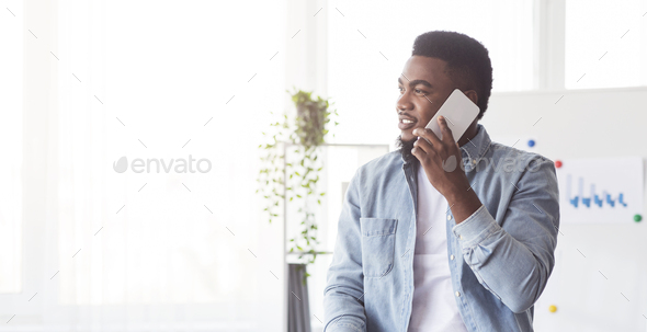 African american ceo talking on cellphone in office