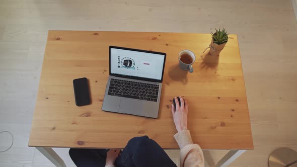 Shopping Online Female Sits at a Desk and Uses a Laptop Surfing the Internet a Woman Visits Online alt