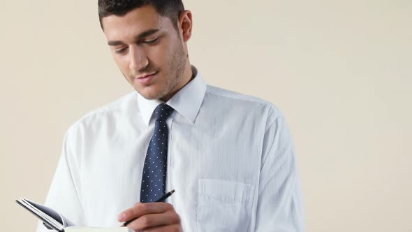 Executive writing on diary against white background 4K 4k alt