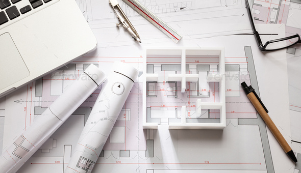 Construction concept. Residential building drawings and house model ...