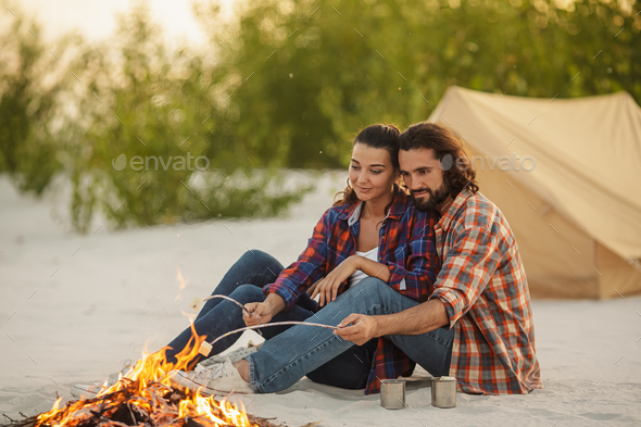 Couple Camping Near Campfire - Stock Photo - Images