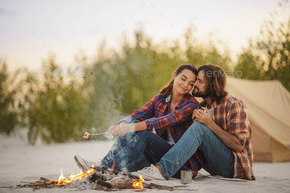 Couple Camping Near Campfire - Stock Photo - Images