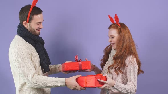 Attractive Young Couple Is Ready To Exchange Christmas Gifts alt