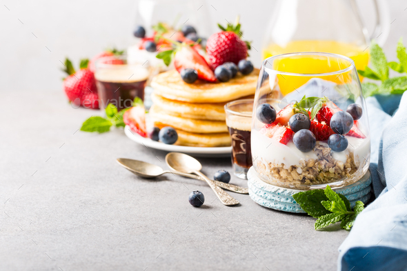 Breakfast with granola, pancakes and berries - Stock Photo - Images
