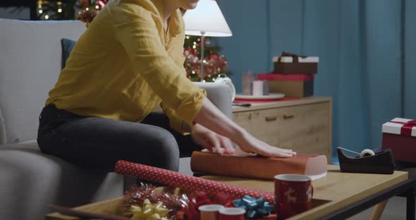 Woman preparing Christmas gifts at home