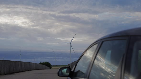 Car Stopped with Windmills in the Background