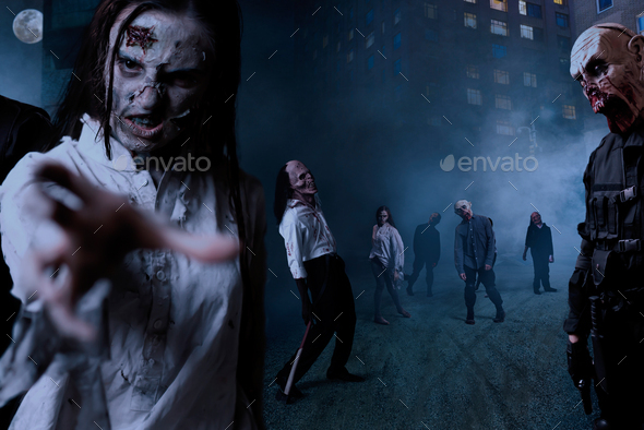 Zombies with bloody faces on night street, monster