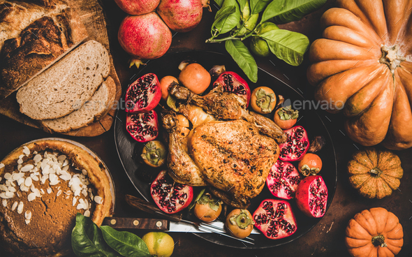 Thanksgiving table with roasted turkey and pumpkin pie, top view - Stock Photo - Images