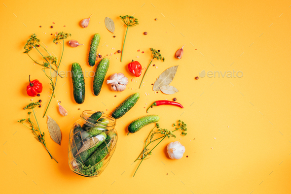 Pickling cucumbers in cans. Ingredients for marinated gherkins, glass jar, garlic, dill, salt - Stock Photo - Images